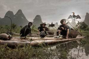 fishermen float bamboo rafts along the river