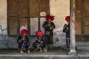 The Dao Do "Red Women" sitting at the doorways