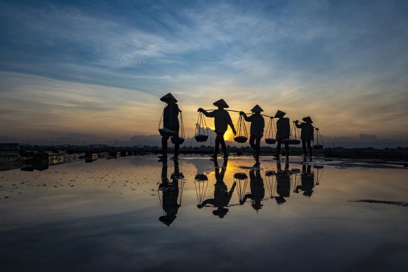 Silhouette reflection on the salt pools at dawn